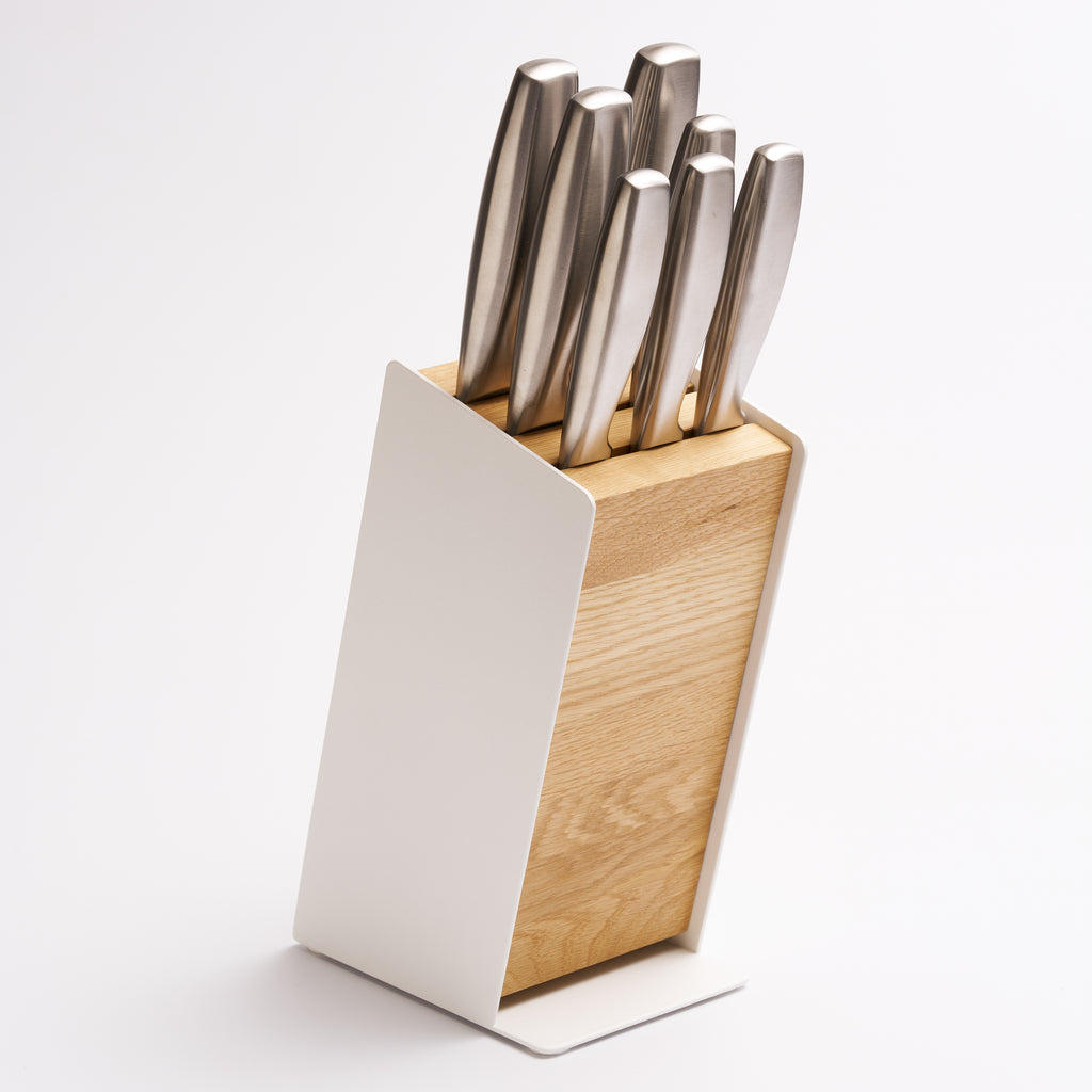 Universal knife block made of steel and wood from Apto holding seven knives with white background. 