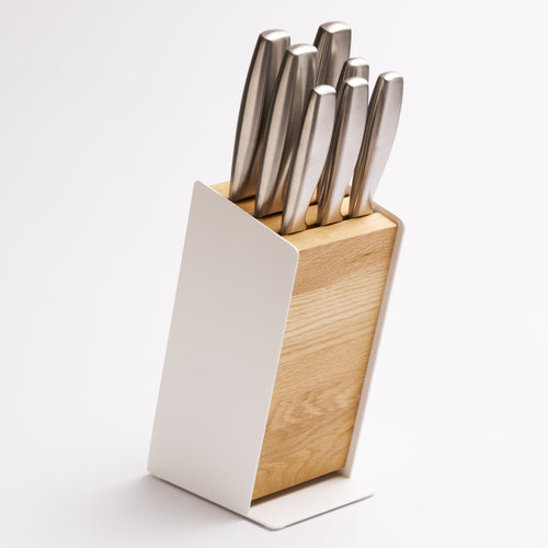 Universal knife block made of steel and wood from Apto holding seven knives with white background. 