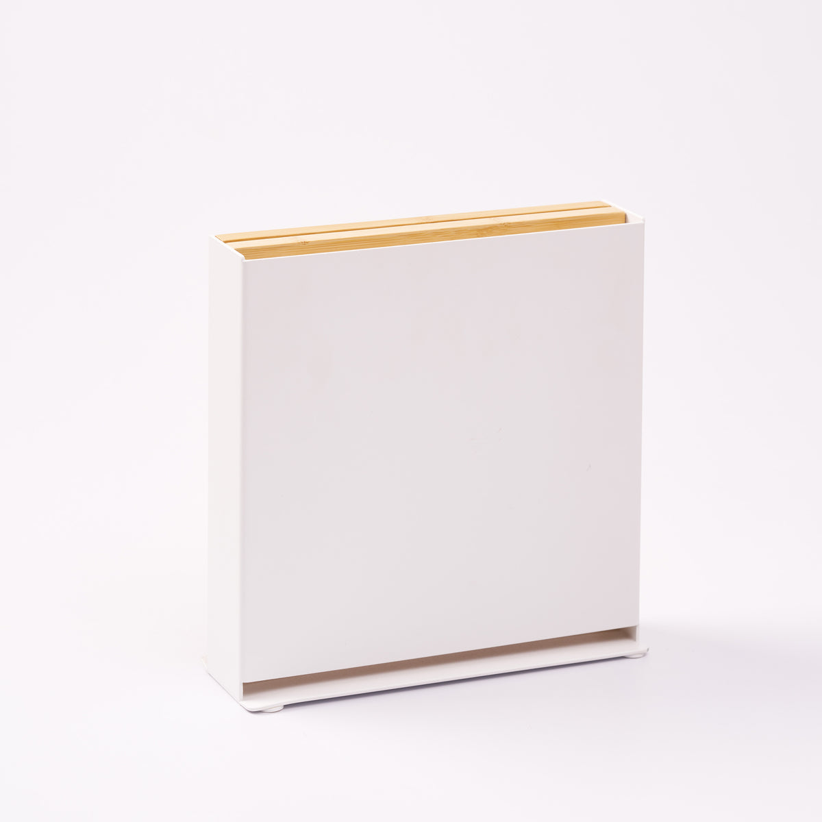Universal knife holder from Apto with bamboo removable cutting board, showing the steel side of the stand. Designed by Apto. 