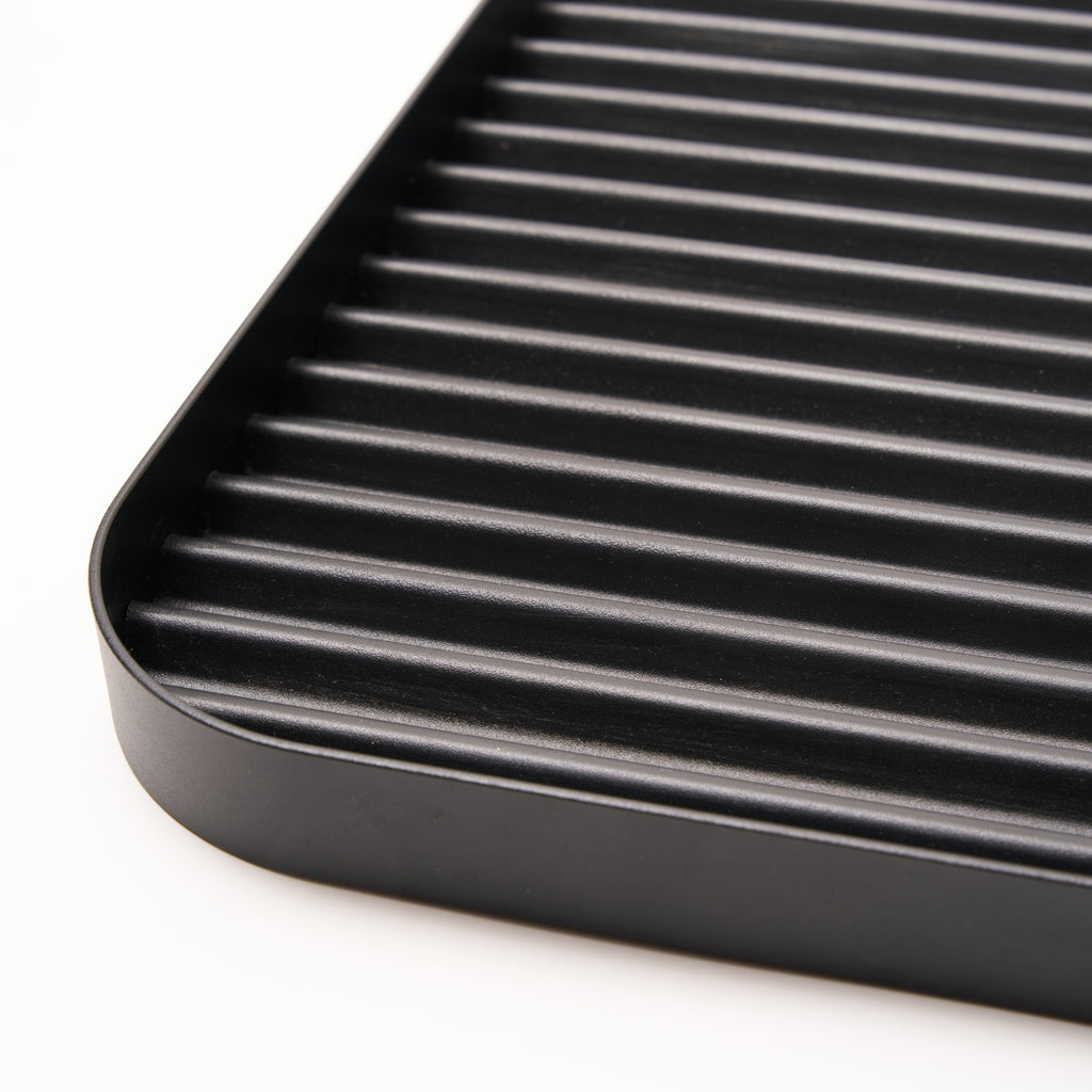 Steel ridges shown in close-up of Black steel boot tray from Apto. 