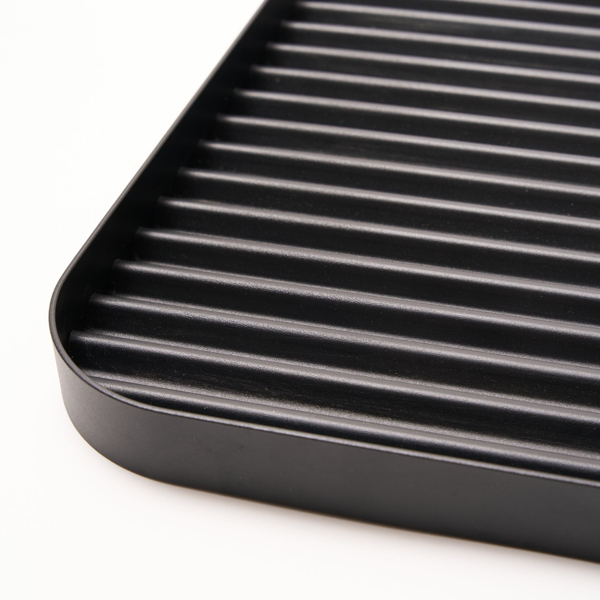 Steel ridges shown in close-up of Black steel boot tray from Apto. 