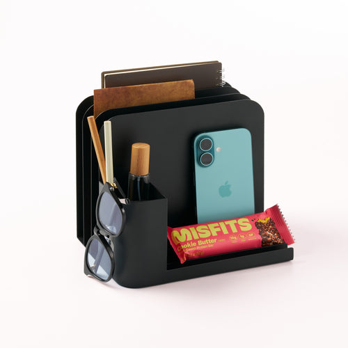 Black steel desk caddy from Apto organizing notes, pencils, glasses, iPhone,   and a snack bar.