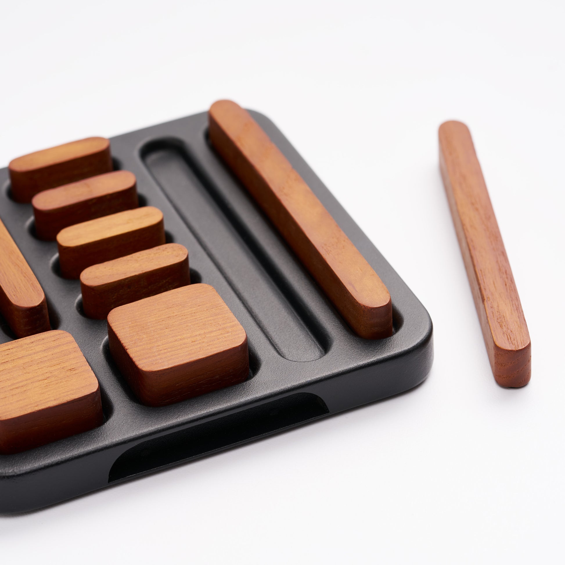 Close-up of tidy magnet set with 9 magnets in holder, one out