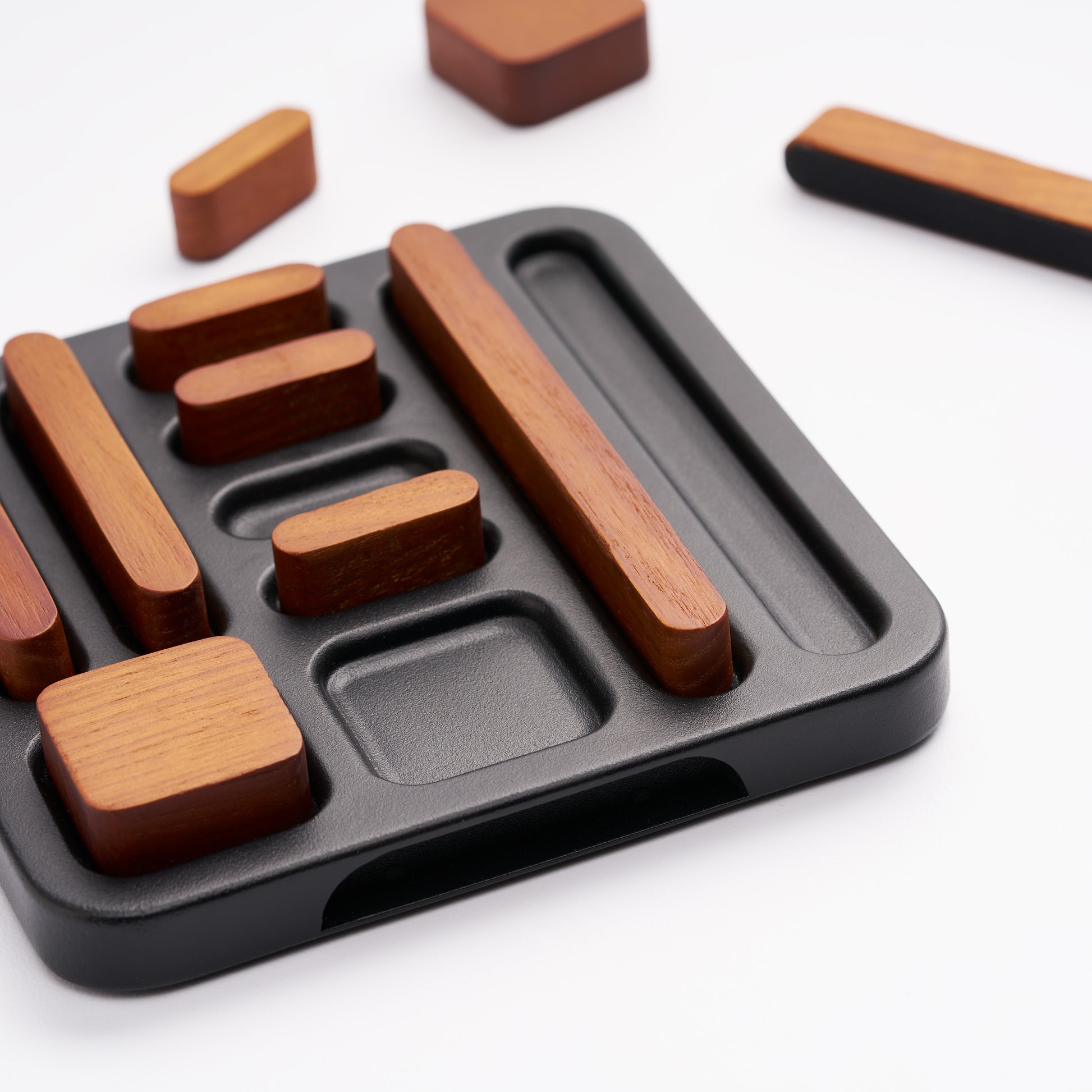 Close-up of tidy magnet set with 7 magnets in holder, three out, one of three showing their bottom side