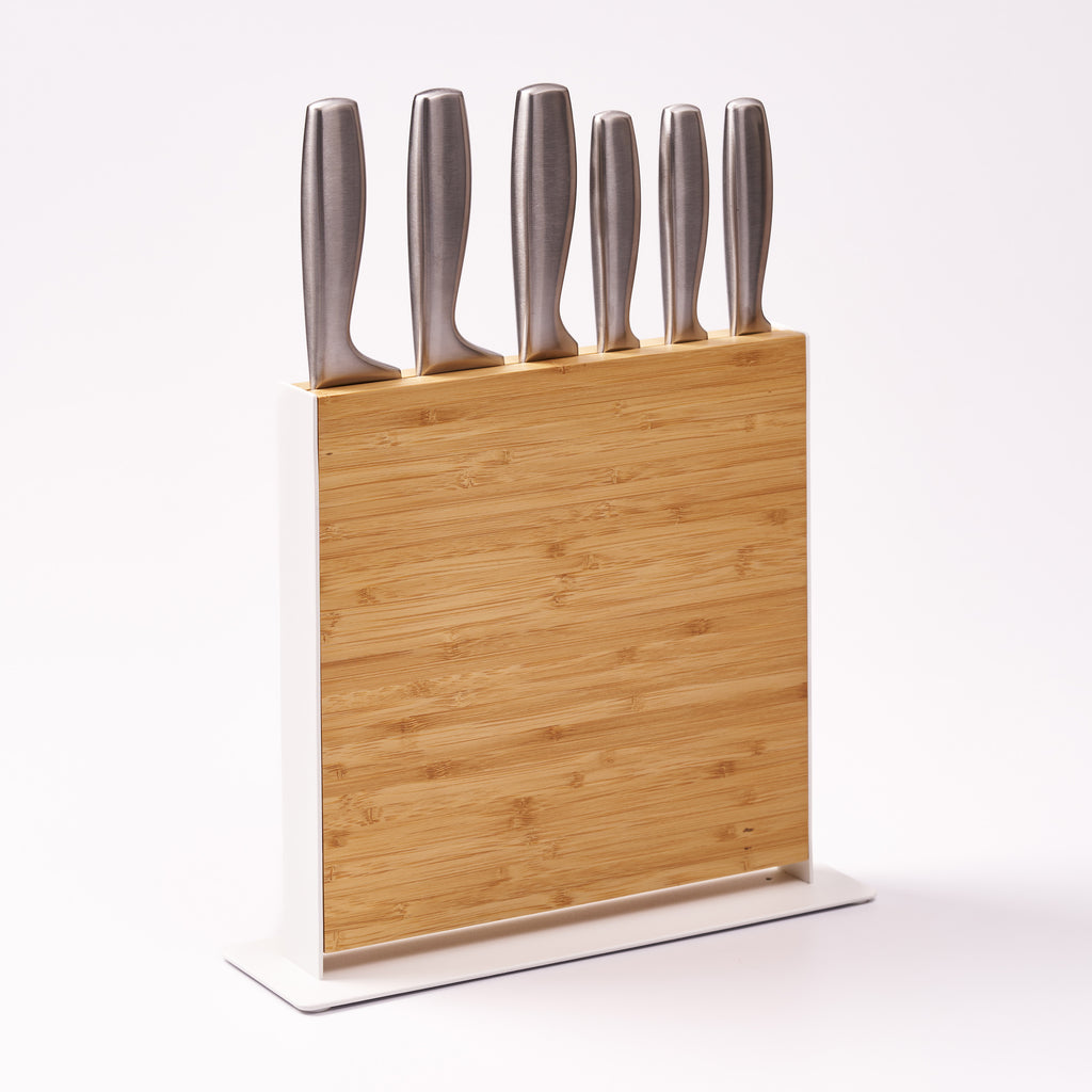 Apto Slot Knife Stand in bamboo and white steel holding six knives of different sizes upright, shown on a plain white background