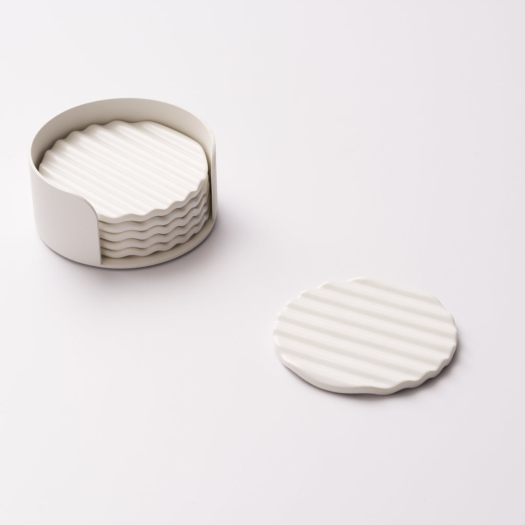 Wave ceramic coaster set in holder with one coaster displayed