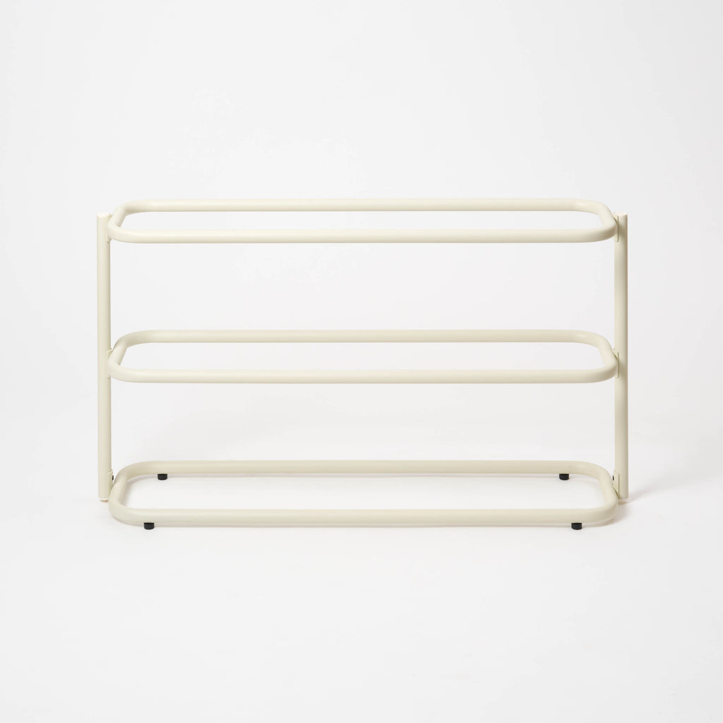 Empty Apto Obround Shoe Rack Short in ivory steel, shown at an angle on a plain white background to show its three rounded tiers