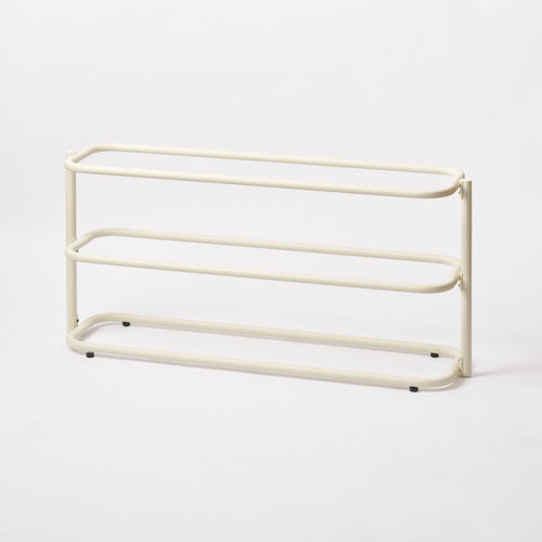 Empty Apto Obround Shoe Rack Short in ivory steel from a side angle, showing three rounded rail tiers on a plain white background