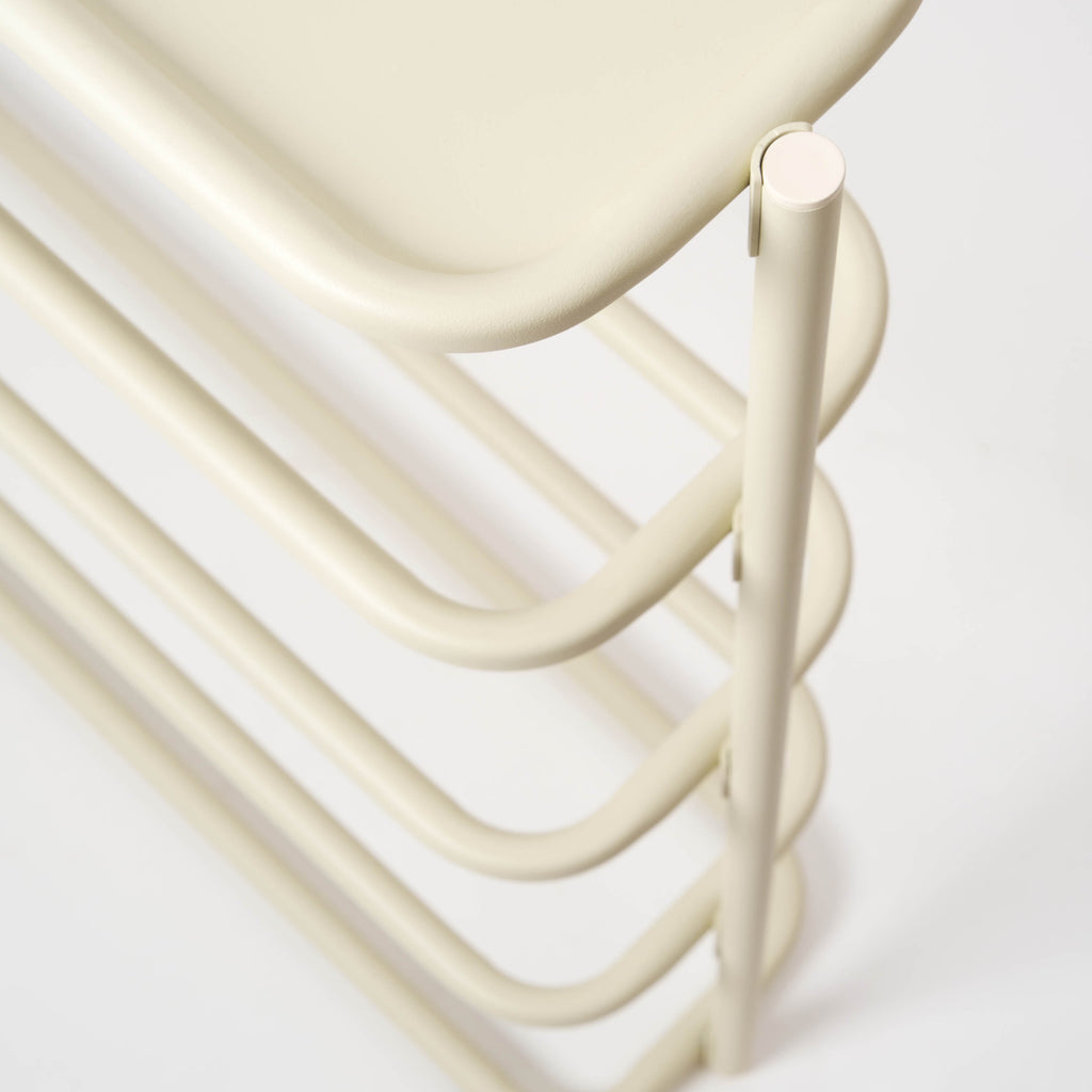 Side view of the white obround shoe rack and entryway table, designed by Apto. 