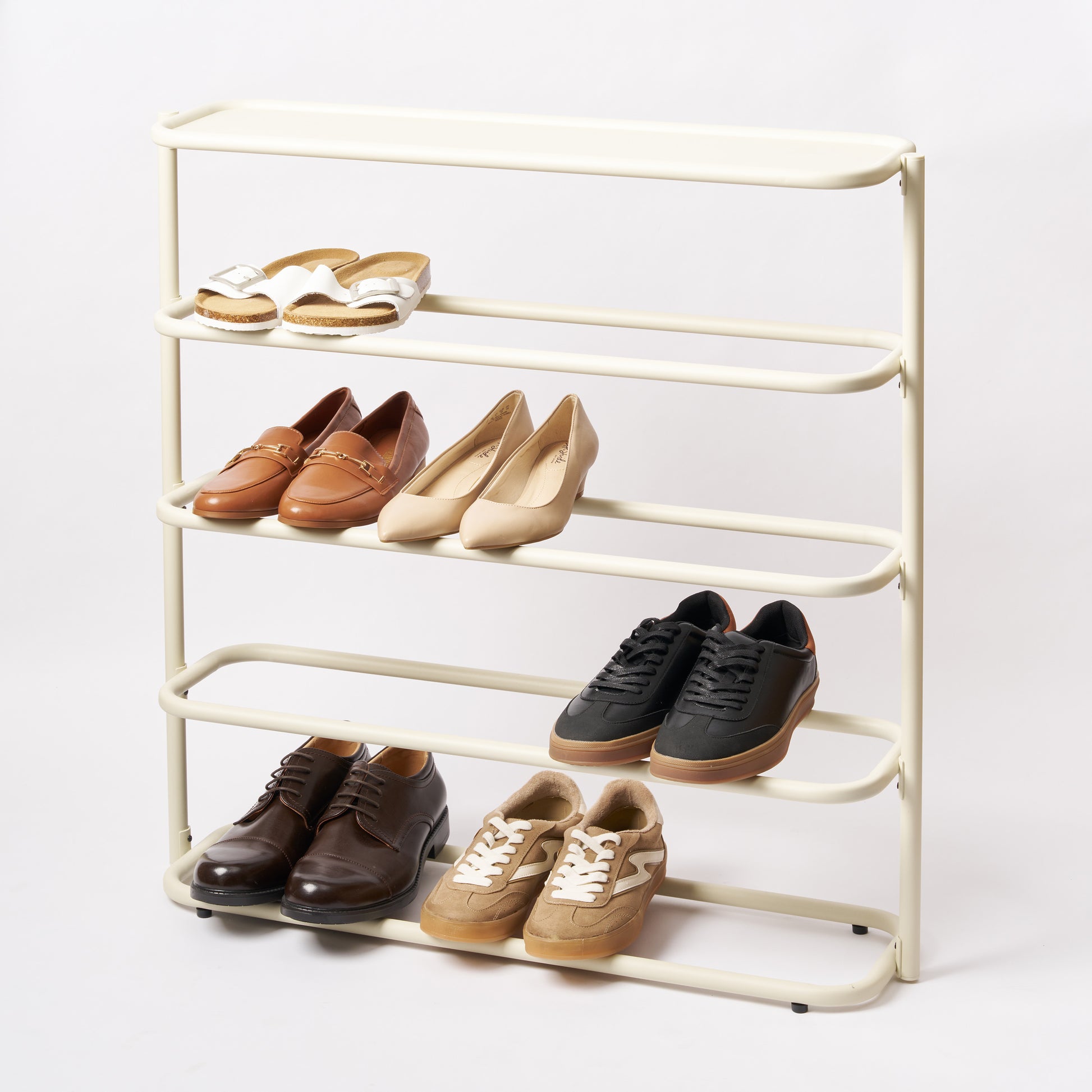 White steel obround shoe rack with four shelves holding 6 pairs of shoes and entryway table. 