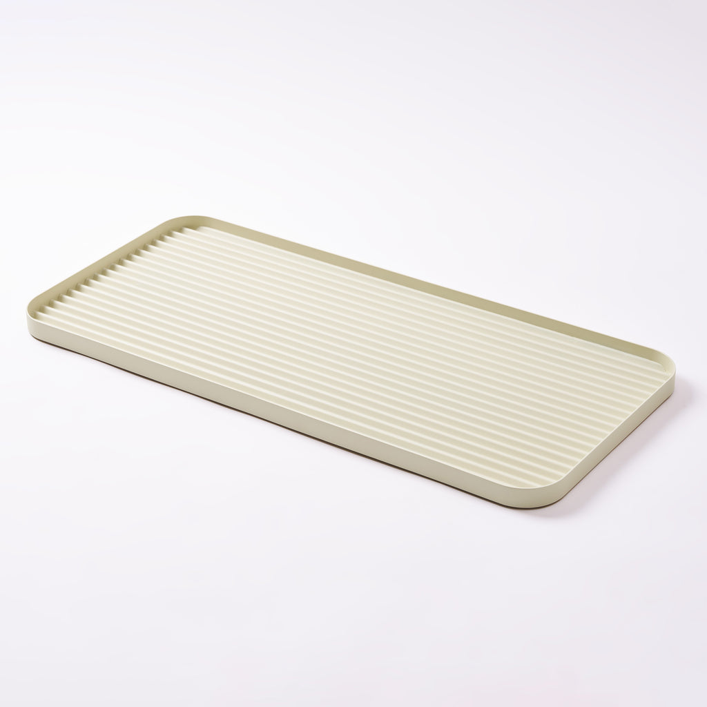 White steel boot tray with ridged bottom on a white backdrop. Designed by Apto. 