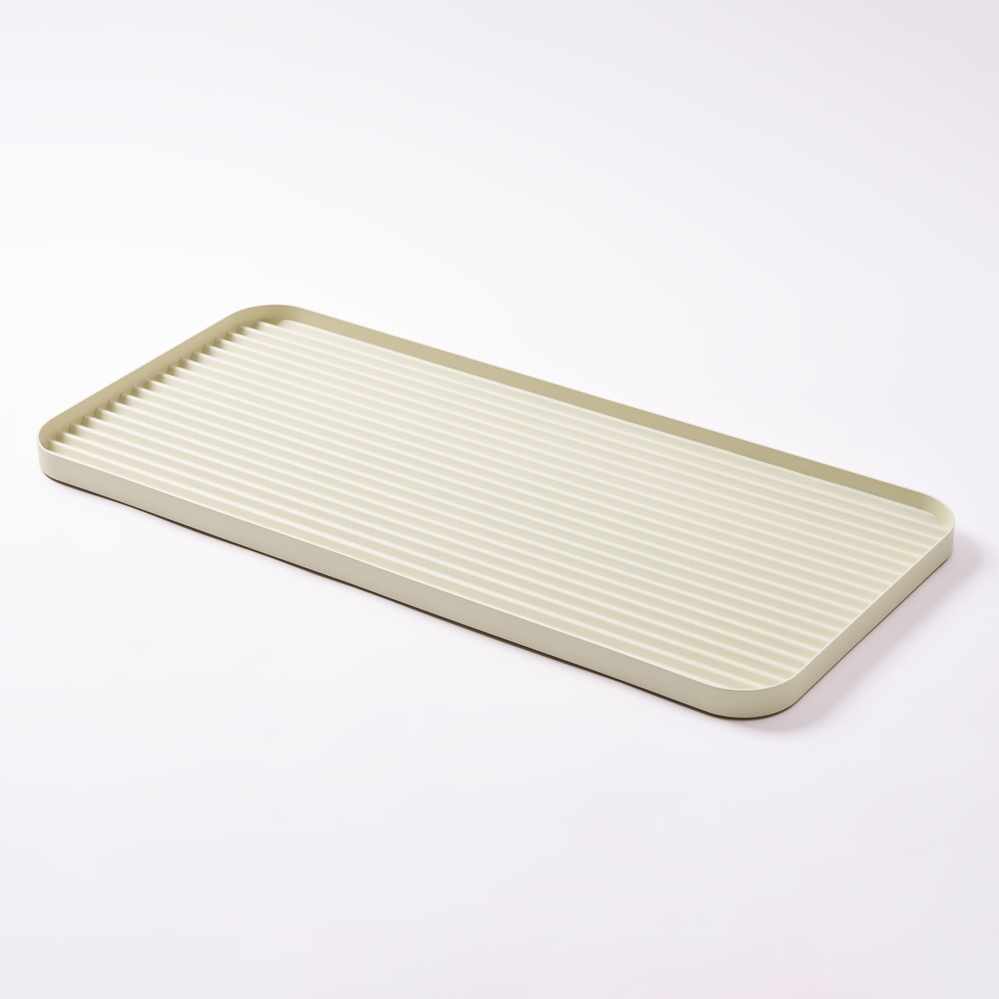 White steel boot tray with ridged bottom on a white backdrop. Designed by Apto. 