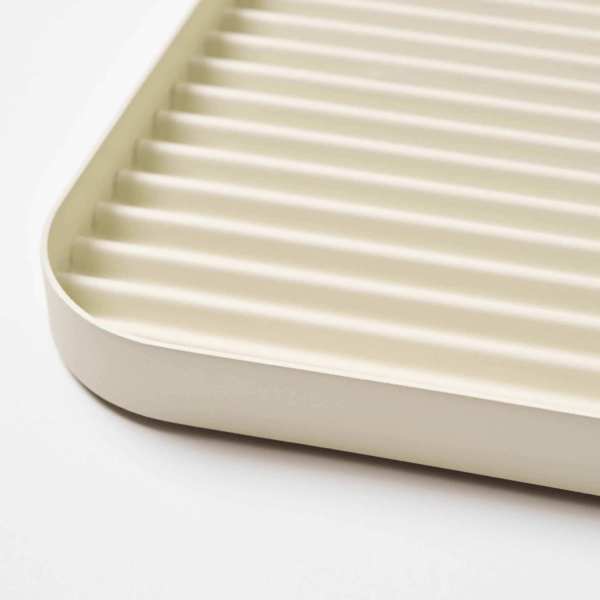 Steel ridges shown in close-up of White steel boot tray from Apto. 