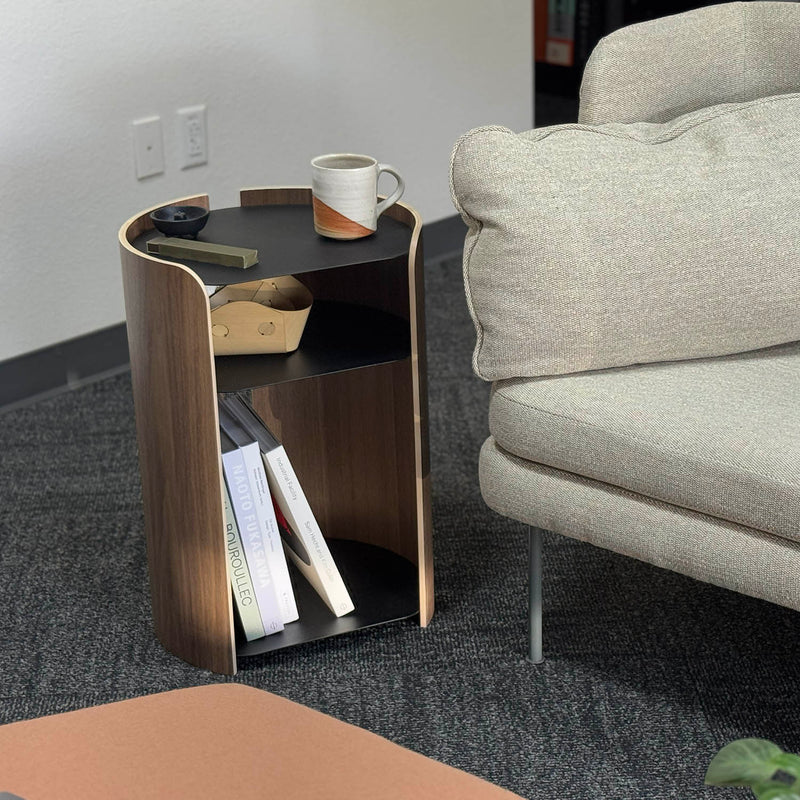 Apto black side table next to the beige sofa.