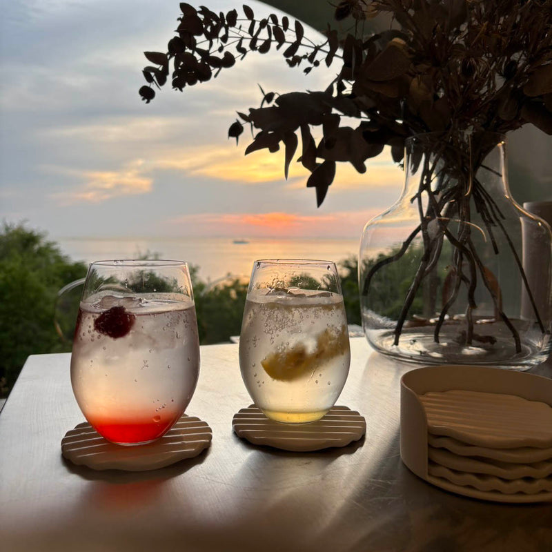 Wave coaster set used for two cocktails on an outdoor table